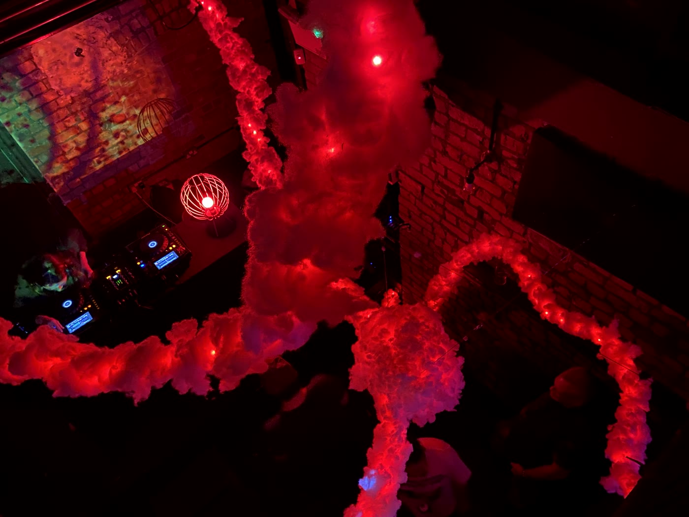 Illuminated LANA installation suspended above a performance space